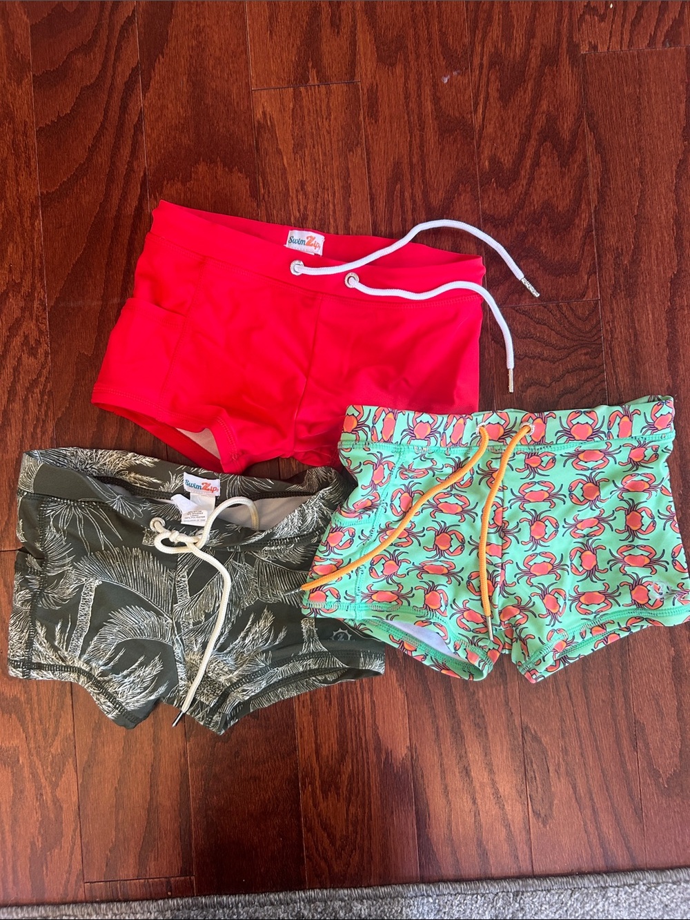 Three-Pair Boys Swim Trunks Set - Red, Green Palm, Mint Crab Print  Runs Size 5